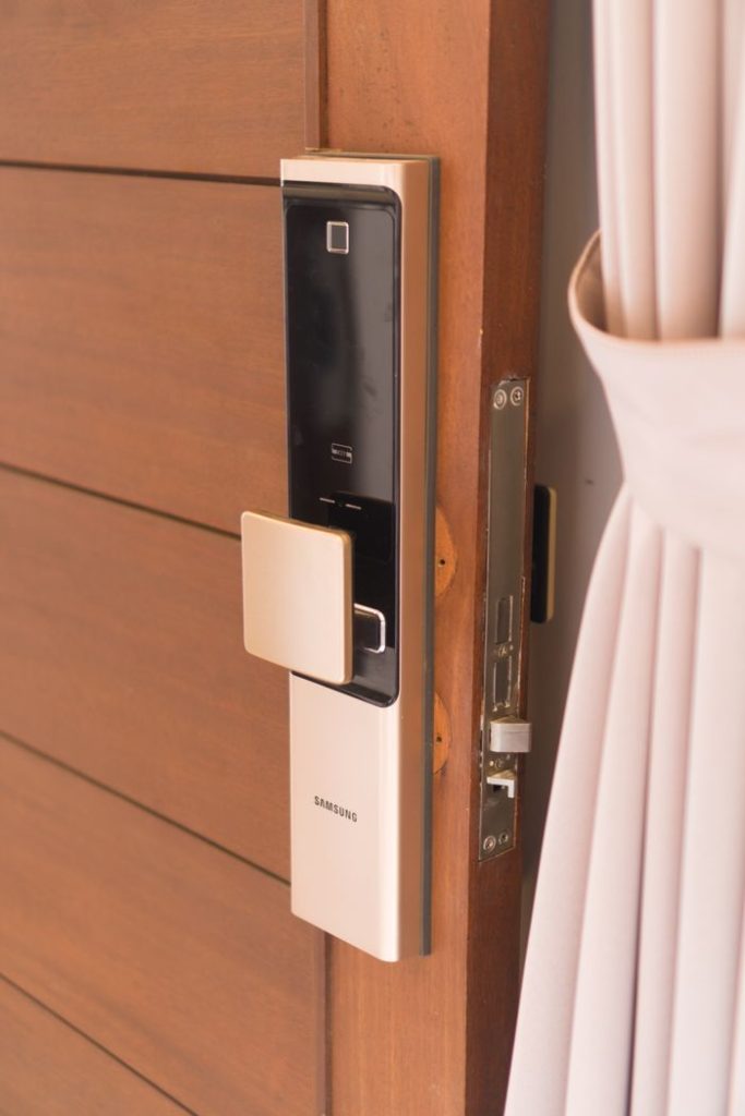 OUR Services Close-up of a smart door lock system, offering enhanced security on a wooden door.